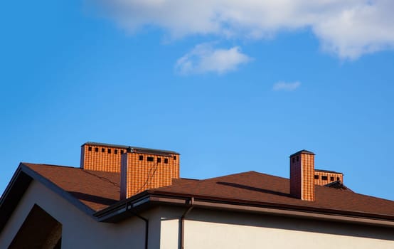 Modern fragment on a construction building, against blue sky, Sunny day