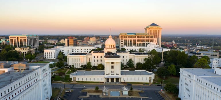 Golden sunlight reaches the horizon showing around the capital statehouse in Montgomery Alabama