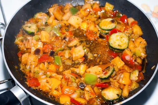 Ratatouille is a French Provencal stewed vegetable dish, originating in Nice. Recipe ingredients include tomato, garlic, onion, zucchini, aubergine (eggplant), bell pepper, and some combination of leafy green herbs common to the region.