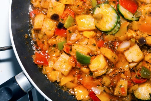 Ratatouille is a French Provencal stewed vegetable dish, originating in Nice. Recipe ingredients include tomato, garlic, onion, zucchini, aubergine (eggplant), bell pepper, and some combination of leafy green herbs common to the region.