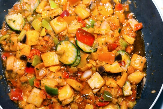 Ratatouille is a French Provencal stewed vegetable dish, originating in Nice. Recipe ingredients include tomato, garlic, onion, zucchini, aubergine (eggplant), bell pepper, and some combination of leafy green herbs common to the region.