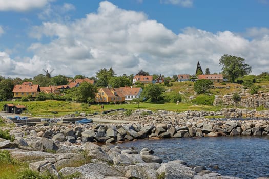 SVANEKE, DENMARK - JULY 4, 2017: View of village of Svaneke in Denmark and modern three-legged water tower designed by Jorn Utzonon.