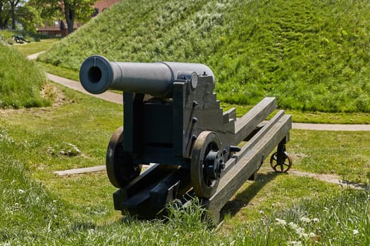 Old bronze cannon on rampart in city Fredericia, Denmark.