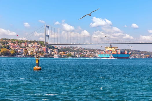 The Fatih Sultan Mehmet Bridge, the cargo ship and the Bosphorus view, Istanbul.