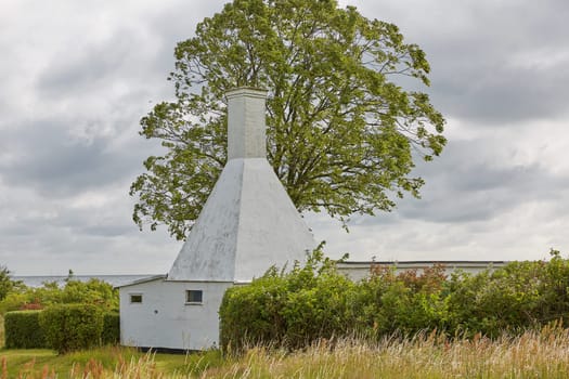 The roofs and chimneys of very small smoke houses so typical and famous for small village of Svaneke on Bornholm island in Denmark.