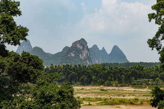View of the unusual mountains in a light haze on a summer day, Yangshuo, China