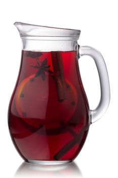 Pitcher of hot mulled wine with species, isolated