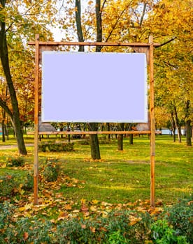 Billboard in the autumn public park. Place for text. Background.