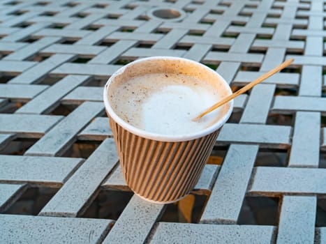 Paper cup with coffee drink on the table. Beverages. Backgrounds. Place for text.