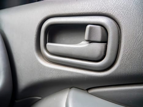 The handle to open the door of the car from the inside. Place for text. Transport.