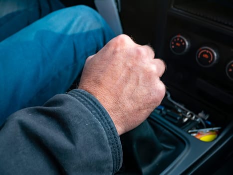 Driver's hand on gear knob. Transport.