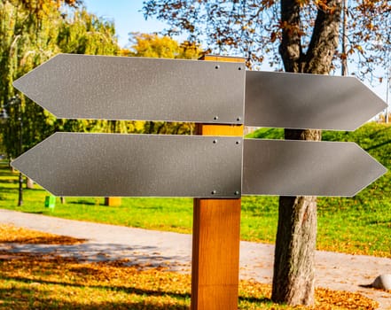 Arrows indicating direction in a public park. Pointer. Place for text.