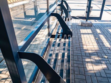 Glass public transport stop with a bench. Background.