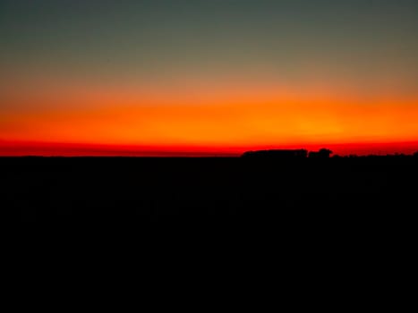 Red sunny sunset on the horizon. Natural background.