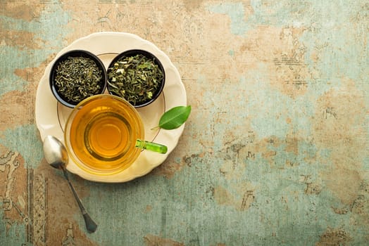 Cup of tea with dry tea collection of different types. Healthy drink concept