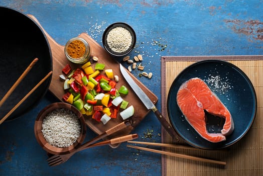 Cooking Chinese food with rice, salmon and vegetables