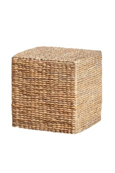 Wicker furniture. Close-up of wicker stool in the form of a cube is also used as a storage next to couches at the hotel swimming pool. Pool accessories. Macro.