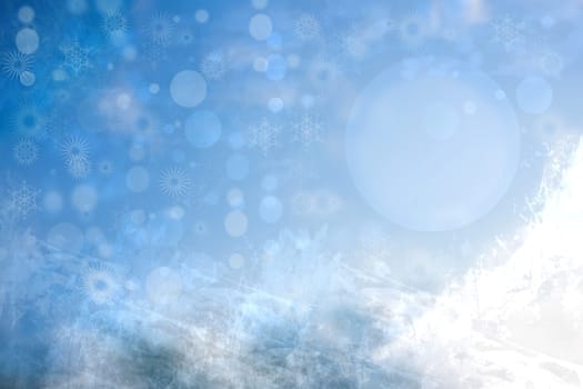 Abstract blurred festive winter christmas background with shiny blue and white bokeh lighted snow mountains landscape with stars and a blue sky.