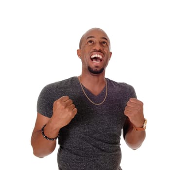 A close up image of a very happy young African American man with .his hands in a fist and mouth open, isolated for white background.