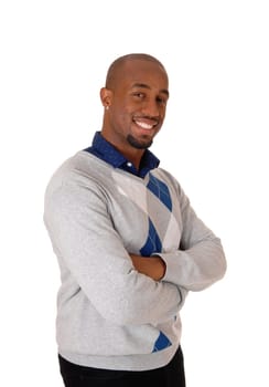 A handsome young African American man standing in a sweater in .profile, looking into the camera, isolated for white background.