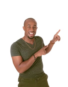 An African American man standing in a sweater and green pants .pointing with his fingers upwards, isolated for white background.