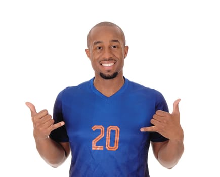 A young African American soccer player standing in the studio in his blue.uniform pointing to himself, isolated for white background.