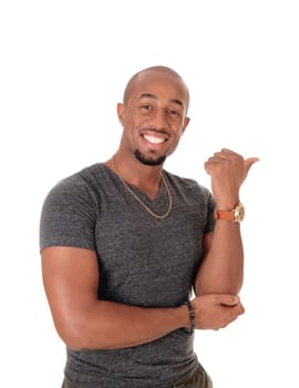 A smiling African American man standing in a sweater pointing with his.thump to the other person, isolated for white background.