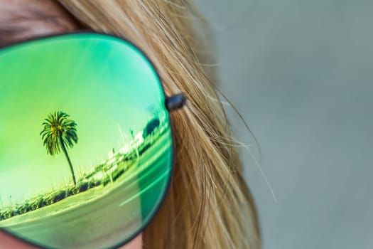 Exciting mirror imaging at sunglasses on head. Beautiful symbol of tourism vacation trip travelling to holiday dream island. Copypace.