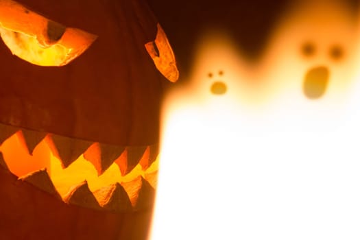Big helloween autumn symbol with mad face, glowing eyes, mouth and teeth. Scary hot nightmare horror with evil smile at october 31st.