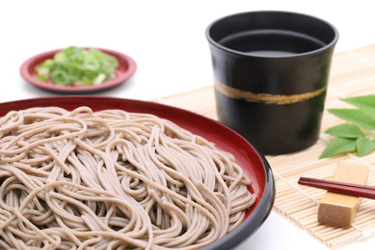 Japanese Zaru soba noodles on wooden plate on white background
