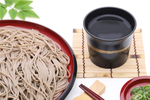 Japanese Zaru soba noodles on wooden plate on white background