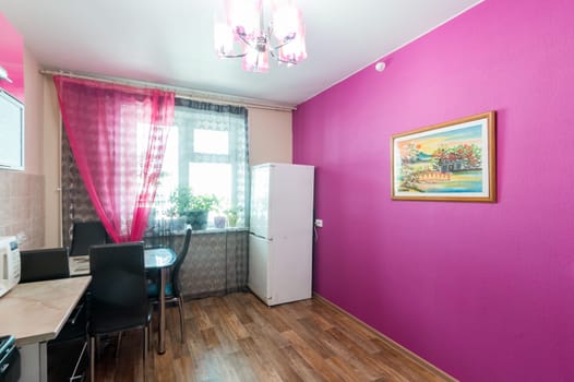Russia, Moscow- June 11, 2019: interior room apartment. standard repair decoration in hostel. modern kitchen, dining area