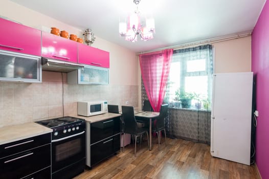 Russia, Moscow- June 11, 2019: interior room apartment. standard repair decoration in hostel. modern kitchen, dining area