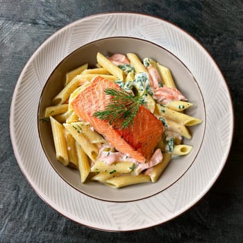 Penne aux deux saumons features creamy dill sauce succulent roasted salmon and smoked salmon for a rich seafood experience.