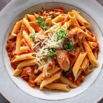 Penne au poulet et chorizo features tender chicken zesty chorizo and creamy sauce topped with melted Parmesan for rich flavors.