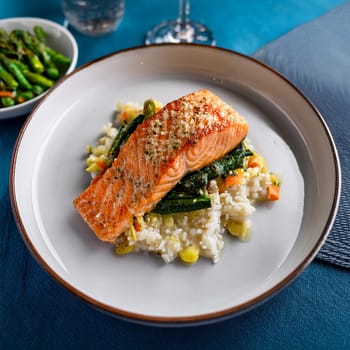 The Pave de Saumon features seared salmon with sautéed vegetables and rice drizzled with a tangy creamy sorrel sauce.