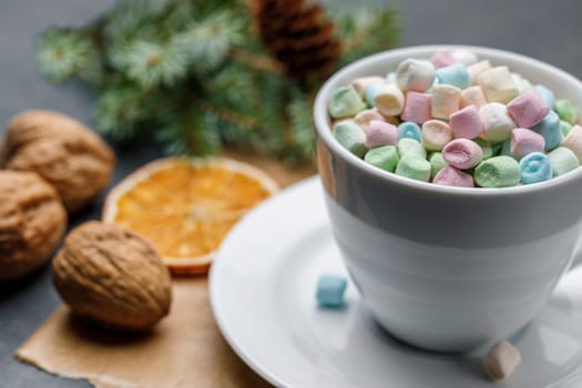 White cup with cocoa and Marshmello on a Christmas background with shallow depth of field