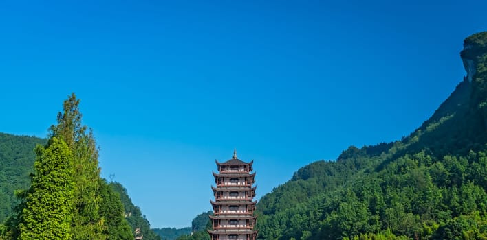 Traditional chinese style wooden tower pagoda standing at the Wulingyuan entrance to the Zhangjiajie national park, Hunan Province, China