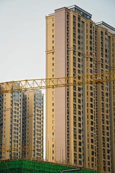 Cranes on the building site of brand new high rise living apartments in the centre of Chengdu, Sichuan Province, China