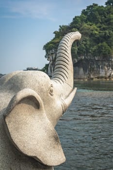 Large marble elephant statue next to the landmark Elephant Trunk Hill Arch and the Li River Lijiang River in Guilin, Guangxi Province, China