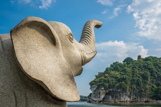 Large marble elephant statue next to the landmark Elephant Trunk Hill Arch and the Li River Lijiang River in Guilin, Guangxi Province, China