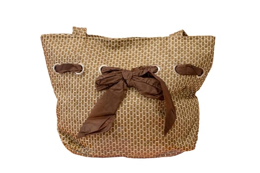 Beach bag. Close-up of a light brown beach bag with a brown bow ribbon isolated on a white background. Concept travel.
