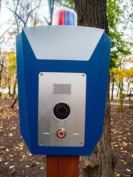 Police emergency call button in a public park. Help. SOS.