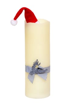 Christmas decorations isolated. Closeup of a large white candle with a light blue ribbon bow and a Santa Claus hat on top of it isolated on a white background. Beautiful xmas design element. Macro.