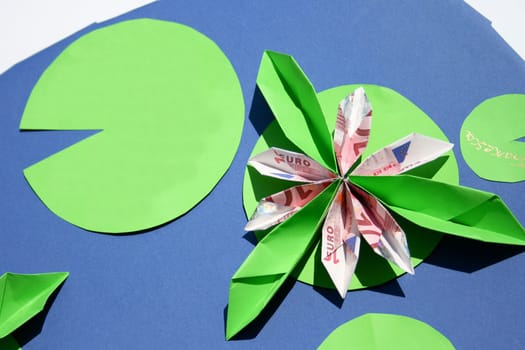 a water lily with leaves and water fashioned from paper