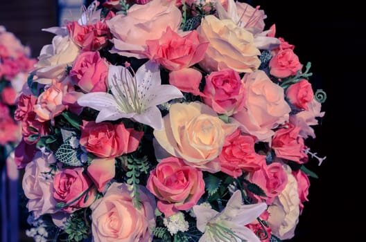 Colorful of outdoor mixed bouquet artificial flowers, vintage filter effect