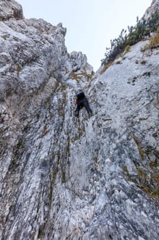 climber on mountain in Piatra Craiului Mountains, Romania