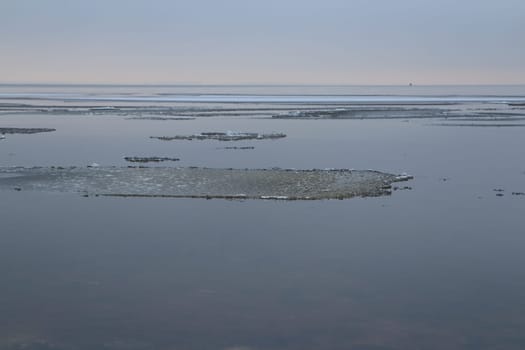 lake freezes is covered with thin ice, a winter landscape