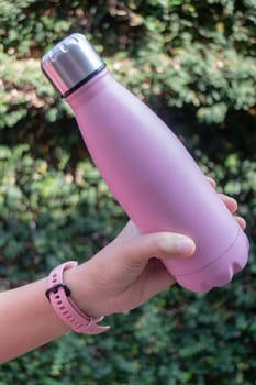 Hand on water bottle for keep temperature, stock photo