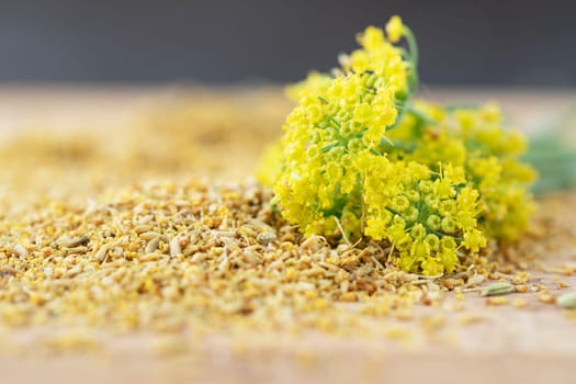 Fennel flower on a small pile of fennel pollen
